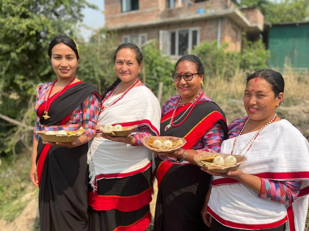 Women hosts presenting traditional Newari food